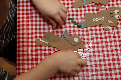 A guest in action creating their own gingerbread man.