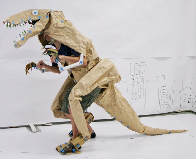 Cardboard dinosaur can walk around.