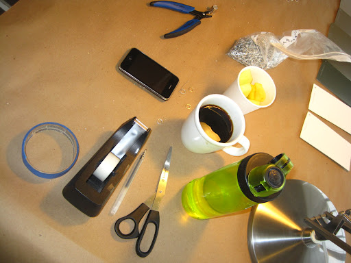 Tools of the trade, from the hole punch and jump rings to water and tea.