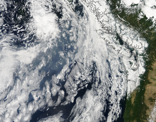 In this image a broad band of gray smoke (center) curls across the North Pacific Ocean between two banks of clouds. In some areas, particularly in the east off of British Colombia, Canada, smoke mixes with the clouds. The fire season in Russia has been intense this year, driven by very dry and hot weather through the spring and summer, which followed a dry and warm winter. Fires continue to burn across Siberia and the Russian Far East. Jeff Schmaltz, MODIS Land Rapid Response Team, NASA GSFC