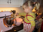 Helping put the flour in