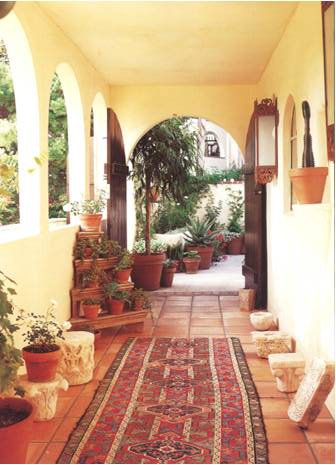 A loggia lined with a Persian rug and enhanced by arched cut-outs.