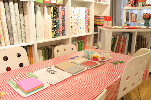 Here one of the tables is set up to make our button cards and the button barrettes.