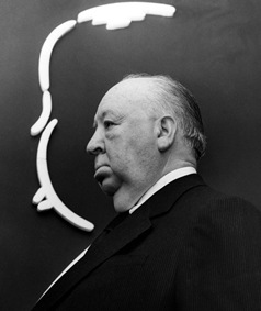 c0 Alfred Hitchcock standing in front of his signature 9-stroke caricature