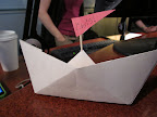 Once the boats are folded, attaching a tootpick mast and paper flag transforms them into placecards.  You could step this step - and the sharp objects - and just write on the boats.
