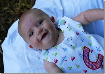 laying on back outside smiling