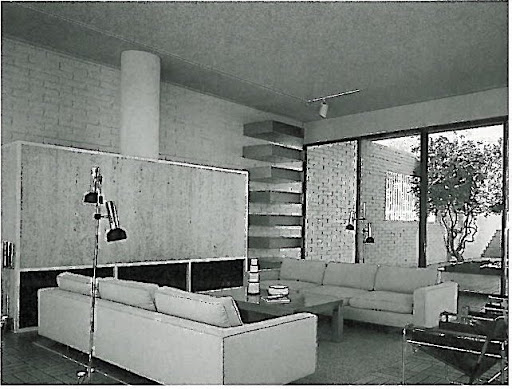 I want to pull every piece of furniture from this photo and place it in my living room! I love everything here - from the clean, crisp sofas to the angular leather and metal chairs and geometric shelving to the right of the mantel. *(correction: the 