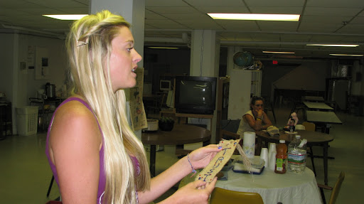 Drury University graduate student Kelley Albers gives instructions to residents of the Missouri Hotel.  On this day, they are making bookmarks and bracelets.