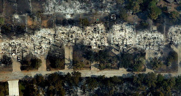 An aerial view shows incinerated houses in the Tahitian Village subdivision in Bastrop, Texas, 7 September 2011. Erich Schlegel / Getty Images