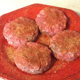The seasoned burgers, ready for the grill-off.