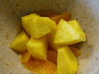 Sliced and chunked pineapple pieces are now added to the orange slices.