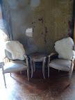 A small room with amazing peeling walls housed a bar, sitting area, and photo booth from We Love Photobooths (welovephotobooths.com).