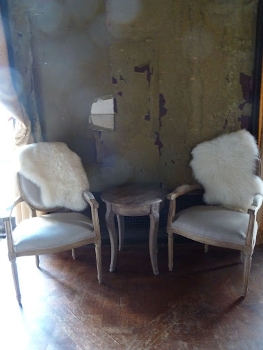 A small room with amazing peeling walls housed a bar, sitting area, and photo booth from We Love Photobooths (welovephotobooths.com).