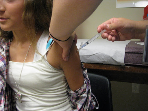 A young woman receives a shot at the Westside Public Health Center in Springfield. Photo credit: Marrie Yvonne Ochieng