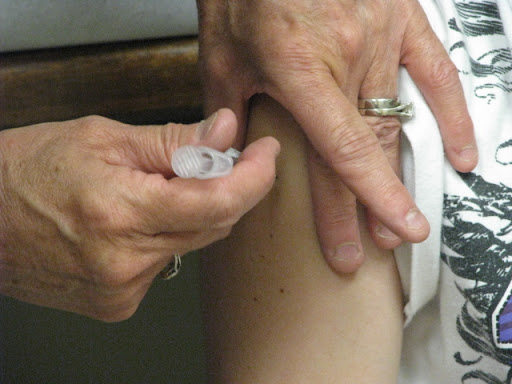 Nurse Leslie Davis administers a shot