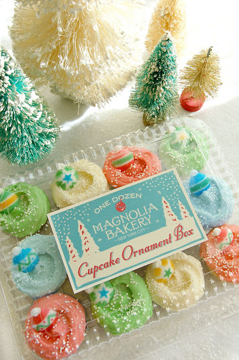 Deck the halls with cupcake ornaments! This box consists of an assortment of mini chocolate and vanilla cupcakes with Christmas-colored icings and sugar ornaments. Deck the halls with cupcake ornaments! This box consists of an assortment of mini chocolate and vanilla cupcakes with Christmas-colored icings and sugar ornaments.