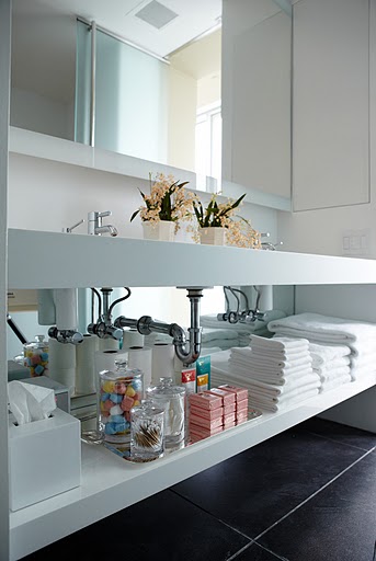 Here, my everyday essentials are stacked on top of a large sterling silver tray, which makes anything and everything look a little more chic.  There was no built in storage so my contractor Bob Tobin built the shelf and installed a custom-fit mirror made by Desiron to create more depth.
