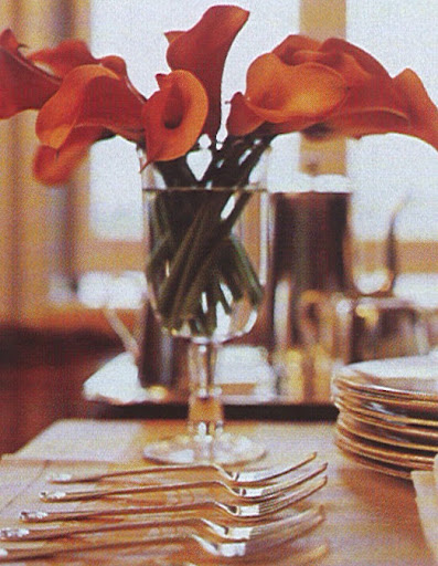 Orange calla lilies decorate the dessert table.