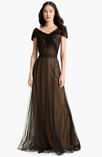 For black tie at an unbelievable price point, this Tadashi Shoji gown sold on Saks.com flatters with a ruched bodice and stays delicate and romantic with a portrait neckline and frothy black tulle. For black tie at an unbelievable price point, this Tadashi Shoji gown sold on Saks.com flatters with a ruched bodice and stays delicate and romantic with a portrait neckline and frothy black tulle.