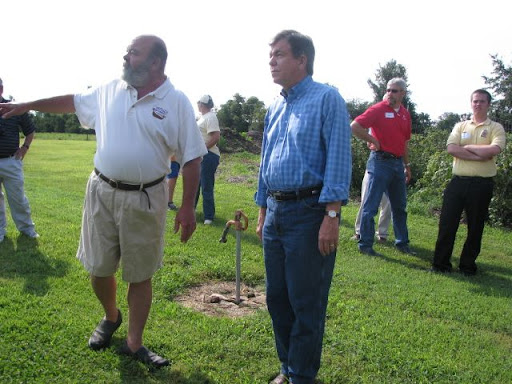 Winery owner Brian Overboe (left) points to his raspberry crops; he says it takes at least one pound of raspberries to make one bottle of raspberry wine.