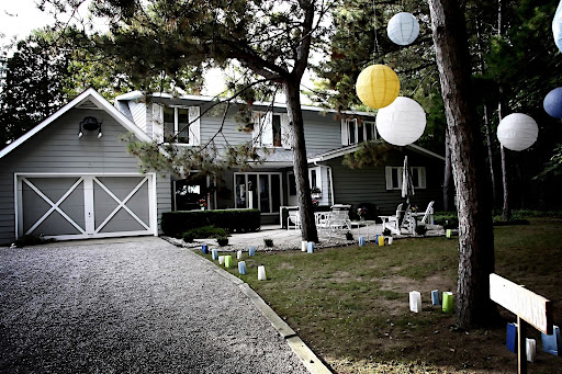 Hanging paper lanterns and colorful paper bag luminarias decorated the lawn. Hanging paper lanterns and colorful paper bag luminarias decorated the lawn.