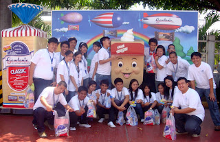 February 25: Students pose behind famous Gardenia product.