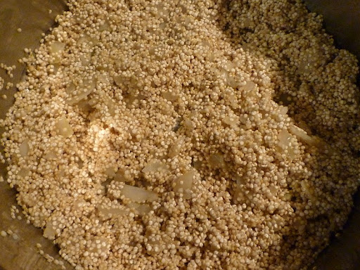 Add the rinsed quinoa to the pan with the cooked onion and garlic.