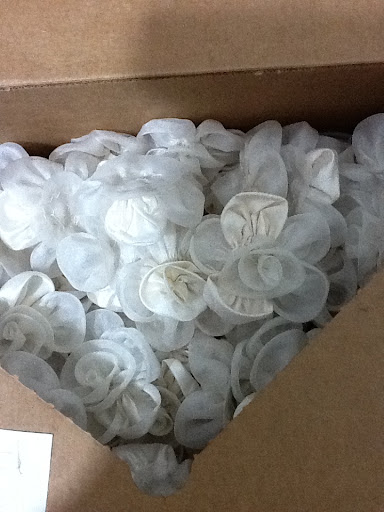 Here, hundreds of flowers waiting to be attached to Rosma's dress.