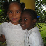 Sweet Ruth and Lucia are in matching white smocked dresses
