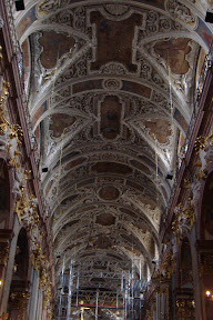 High ceilings.  Baroque-style ornaments.  Scaffolding.