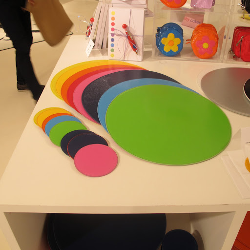 All of the place mats spread out, with some cute stationary and coin purses in the background.