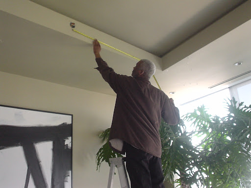 Junior begins taking measurements to get an idea of the size of the space.