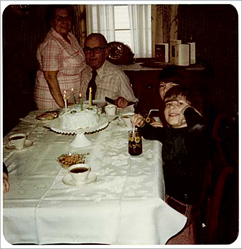 c0 This is my Grandpa Cairns (my dad's dad) in 1975 on his birthday. I am immediately to his left, partly hidden by my brother Tom. Of course, that's Grandma (Geneva Cairns, née Bauer) next to Grandpa.