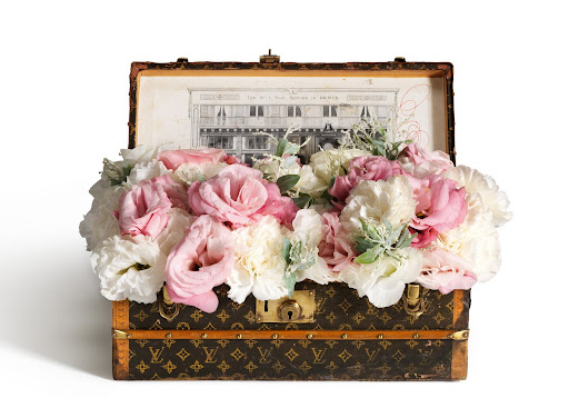 A flower trunk holding a mix of gorgeous blooms, complete with a zinc tray and monogrammed paper. A flower trunk holding a mix of gorgeous blooms, complete with a zinc tray and monogrammed paper.