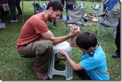 Alex in an arm wrestling match with the local strong man boy