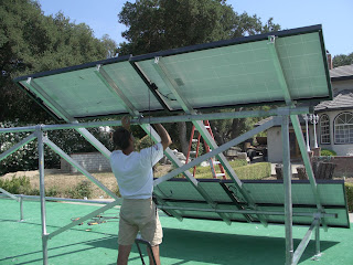 Panels were arranged on flat surface, rails were then placed over the panels in the correct position. Due to the weight of the panels, only the upper and lower panels were actually bolted to rails. After this assembly was secured to rack the inner areas would be filled with remaining panels. Shane is attaching "U-Bolts" around 2" rigid and into mounting plate of the Uni-Rac HD rails.