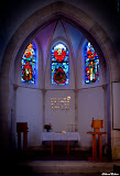 The apse of the church with the three central windows and the altar with the Menorah. In between, a verse from John 3:16 that puts in a nutshell what God's great master plan all through the TaNaK and New Testament is about: "For God so loved the world that he gave his one and only Son, that whoever believes in him shall not perish but have eternal life." StainedWindows-0858.jpg