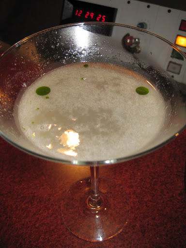 A vodka based heirloom tomato martini with droplets of basil oil. A vodka based heirloom tomato martini with droplets of basil oil.