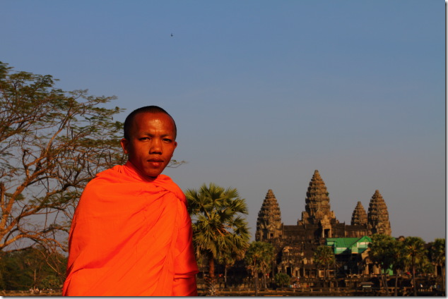 Buddhist Monk poses in front of Angkor Wat
