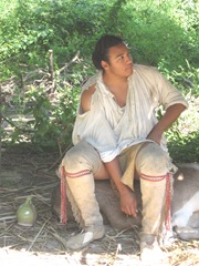 Plimoth Plant male indian sitting on log Plimoth Plant male indian sitting on log