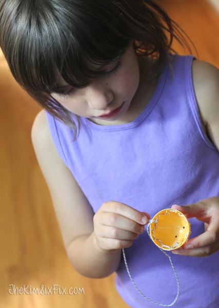 Child sewing easter egg