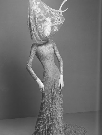 Real antlers were used to poke through the lace embroidery of the piece. 