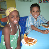 Miguelina and Raidi cant wait to enjoy their pizza.