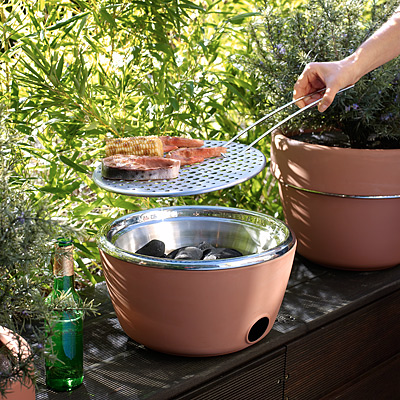 What a stealthy little grill. This compact grill doubles as a planter, but you can whip off the top to use the hidden barbeque. (uncommongoods.com) What a stealthy little grill. This compact grill doubles as a planter, but you can whip off the top to use the hidden barbeque. (uncommongoods.com)