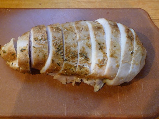 Cooked chicken breast halve, sliced crosswise.