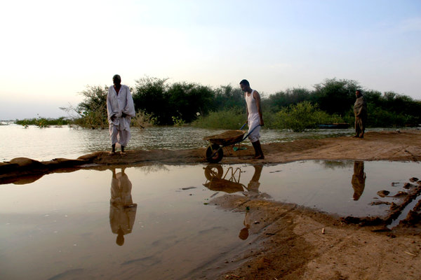 Men built a barrier to protect their houses from rising water in Khartoum, Sudan, during the last week of August 2013. More than 300,000 people were directly affected by the flooding, and dozens died. Photo: Reuters