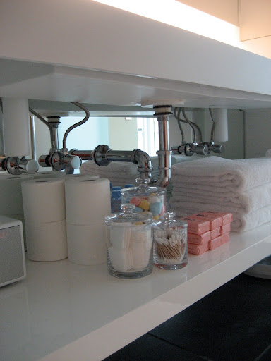 I love the openness of the shelves and have no problem seeing useful items. I do, however, coral them in clear jars.