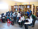 Lora helping the kids with some of their reading at the library's grand opening. South Africa - 477.jpg
