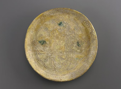 Dish | Origin:  Iraq | Period: 9th century  Abbasid period | Details:  Not Available | Type: Earthenware with molded decoration underglaze | Size: H: 2.8  W: 28.0  cm | Museum Code: F1957.23 | Photograph and description taken from Freer and the Sackler (Smithsonian) Museums.