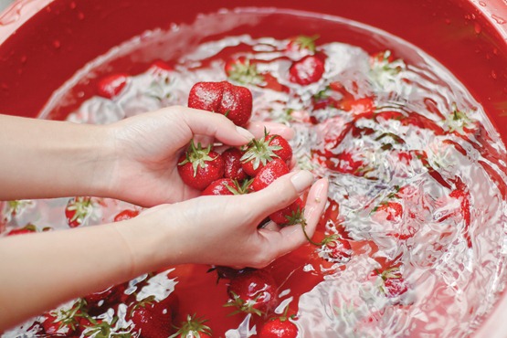 Giving the strawberries a good rinse in the backyard.